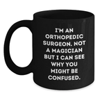 Funny Orthopedic Surgeon Gifts - 'I'm Not A Magician But I Can See Why You Might Be Confused' Birthday Mug for Orthopedic Surgeon Doctors, Unique Black Coffee Mug from Friends - Main