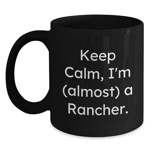 Rancher Humor Funny Quote Black Coffee Mug Gifts for Men from Friends, Christmas Unique Mugs for Rancher Enthusiast, Keep Calm I'm almost a Rancher Black 11oz or 15oz Ceramic Mugs - Main