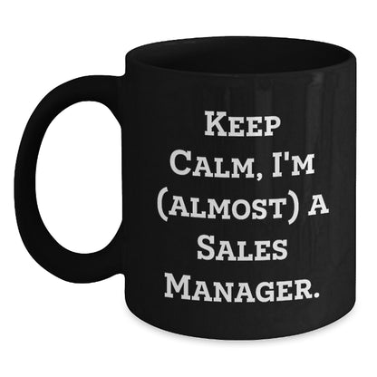 Funny Sales Manager Gifts from Friends - Keep Calm I'm (almost) A Sales Manager. Black Ceramic Coffee Mug for Birthday - Main