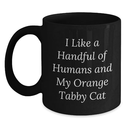 Funny Orange Tabby Cat Gifts from Family for Orange Tabby Cat Lover Christmas Unique Mugs, Black Coffee Mug, I Like A Handful Of Humans And My Orange Tabby Cat - Main