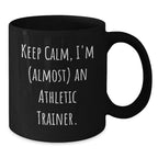 Funny Athletic Trainer Black Coffee Mug, 'Keep Calm, I'm (almost) An Athletic Trainer.' Gifts for Athletic Trainers from Friends and Family