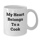 Funny 'My Heart Belongs To A Cook' White Coffee Mug Gifts for Cook Lovers, Unique Graduation Gifts from Family, Friends, or Coworkers