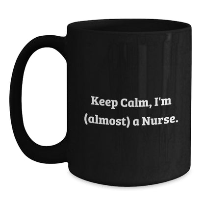 Funny Nurse Gifts for Christmas, Black Coffee Mugs with Keep Calm I'm (almost) A Nurse, Perfect Unique Presents from Family, Friends, Coworkers - Main