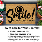 Funny Security Doormat - Smile! You’re on Camera | Coir Welcome Mat for Home Surveillance | Humorous Front Porch Décor