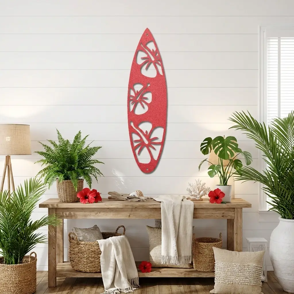 A red surfboard-shaped wall decor piece with white hibiscus flower cutouts, displayed on a white shiplap wall above a rustic wooden console table in a styled tropical room.