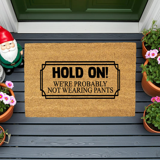 Funny “Hold On! We’re Probably Not Wearing Pants” Coir Doormat – Hilarious Welcome Mat | Humor Front Porch Decor | Gag Gift for Friends & Couples - Mallard Moon